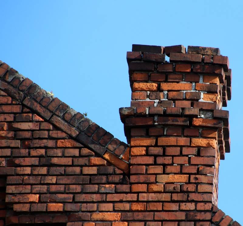 Signs Your Hamilton Home Needs a Chimney Inspection Damaged chimney on an Hamilton home showing cracks and missing mortar